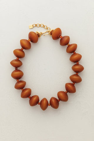 Ambarino Camel Necklace. Spark joy this season with our extra large beaded necklace in a rich camel hue.