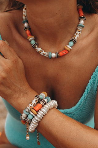 Leo Bracelet, a chunky piece handcrafted with vibrant coral, turquoise, bone, glass beads and freshwater pearls with gold-plated accents.