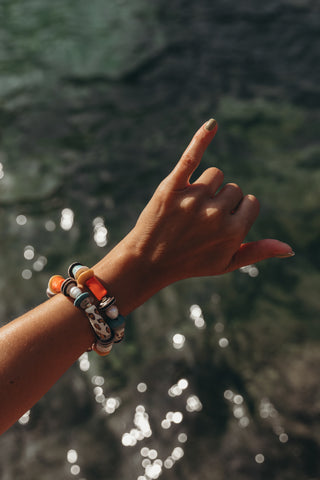 Leo Bracelet, a chunky piece handcrafted with vibrant coral, turquoise, bone, glass beads and freshwater pearls with gold-plated accents.