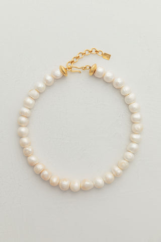 Grandma Necklace, a classic piece featuring round freshwater pearls and gold-plated brass hook closure.