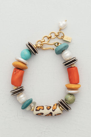 Leo Bracelet, a chunky piece handcrafted with vibrant coral, turquoise, bone, glass beads and freshwater pearls with gold-plated accents.