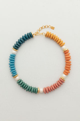 Rainbow Necklace, a piece designed to bring a burst of color and joy to your fall and winter wardrobe.